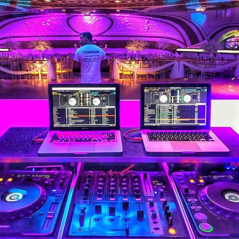 DJ decks glowing purple mid-set