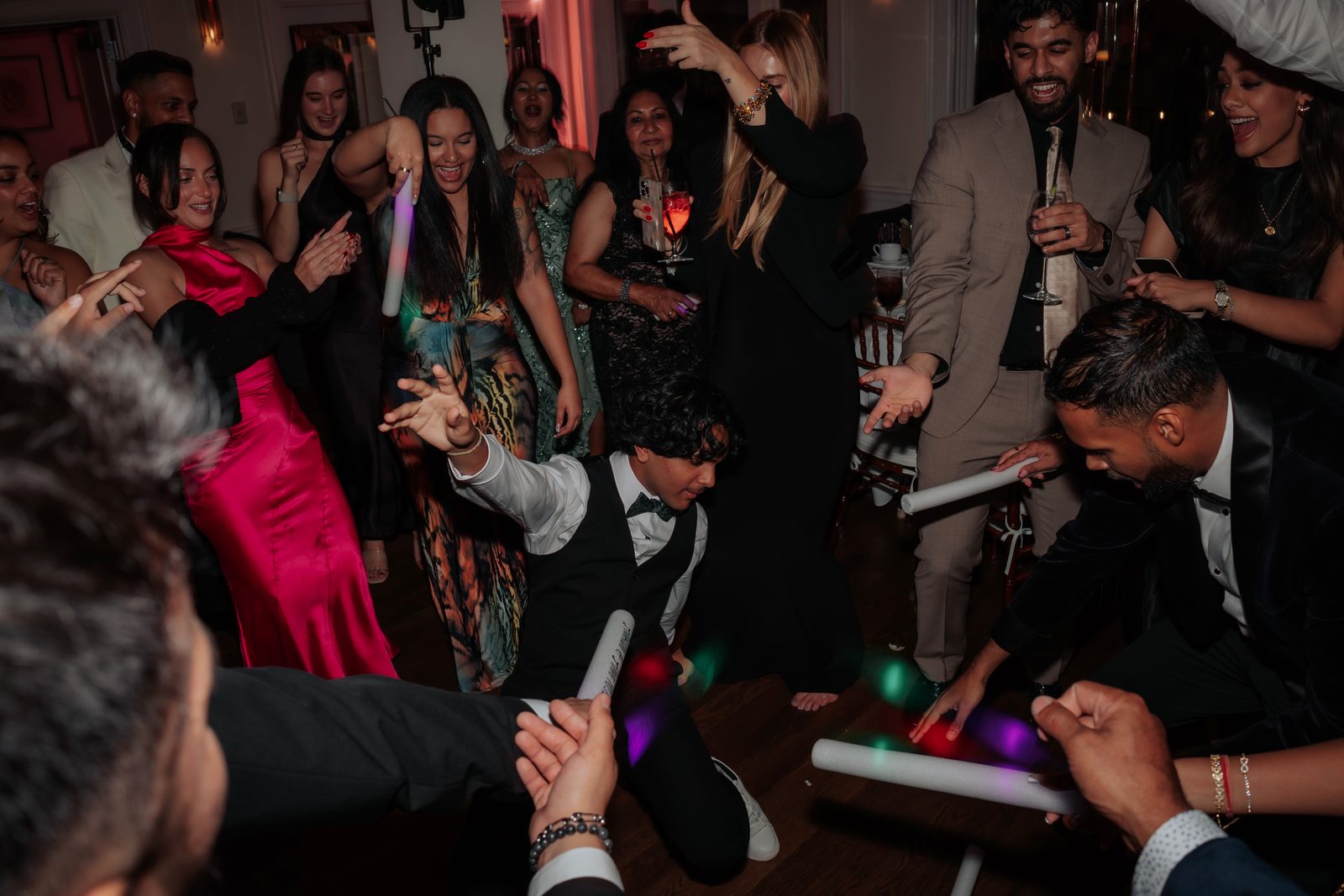 Guests dancing in a circle at a reception