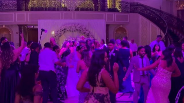 Guests filling the dancefloor at a wedding